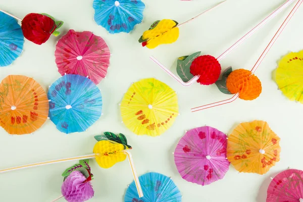 Colorful umbrellas for cocktail on a colored background — Stock Photo, Image