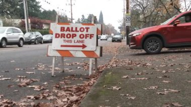 Sign on streets points voters to the ballot drop off site on election day.