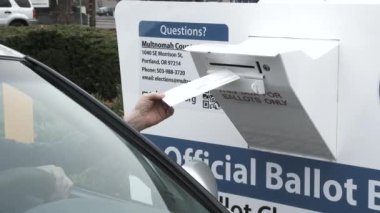 Man drives up to ballot box and casts his vote on election day.