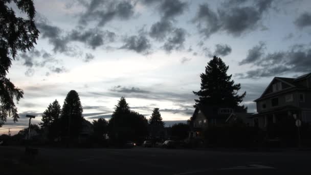 Car Drives Residential Neighborhood Passing Houses Headlights Sunset Sunrise — Stockvideo