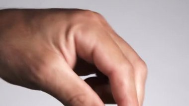 Close up of hand and dipper serving honey, in studio isolated on white.