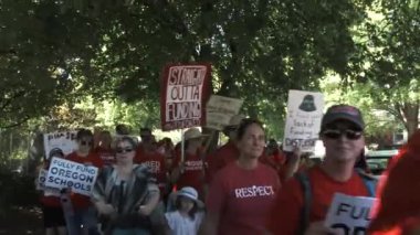 Crowd marching city streets for the #RedForEd campaign supporting teachers, students and to fund their schools.