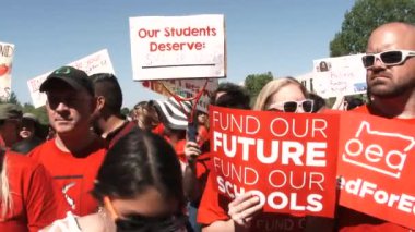 Crowd of teachers and students want congress to fund their schools.