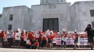 Protesters fill the steps of the Capitol Building shouting and chanting for more school funding.