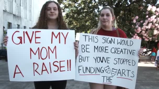 Two Students Holding Signs Standing Better Teacher Wages Funding Arts — Stockvideo