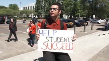 Young man holds sigh reading 