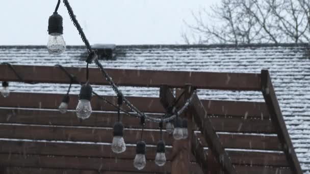 Unexpected Snow Falling Roof House Patio String Lights Scenic — 图库视频影像