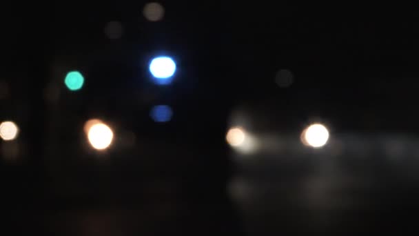 Unrecognizable Blurred Traffic Driving Parked Police Car Flashing Lights Night — Stock Video