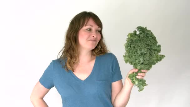 Healthy Happy Woman Eating Raw Kale Isolated White Background — Stock Video