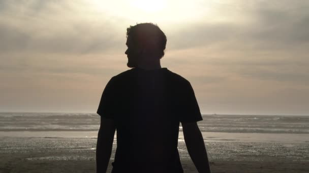 Man Stands Pacific Ocean Putting Sunglasses Walking Camera Edit Transition — Stock Video