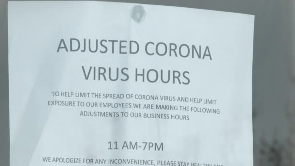 People Walk Door Sign Reading Adjusted Corona Virus Hours Lockdown — Stock Video