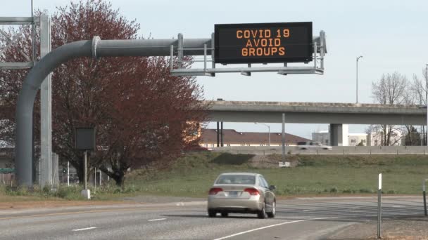 Large Road Sign Reads Covid Avoid Groups Vehicles Commute Highway — Stock Video