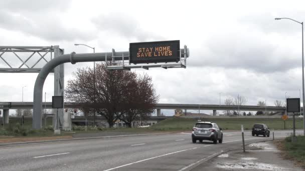 Road Sign Reads Stay Home Saves Lives Interstate People Driving — Stock Video