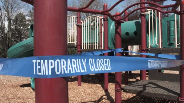 Static Shot Empty Playground Caution Tape Reading Temporarily Closed Due — Stock Video