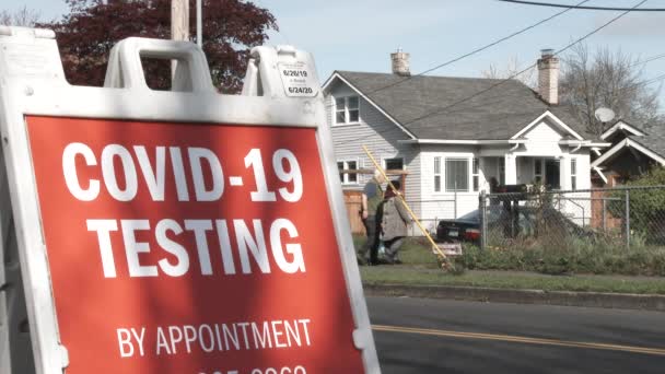 Older Couple Walk Neighborhood Passing Sign Offering Covid Testing Appointment — Stock Video