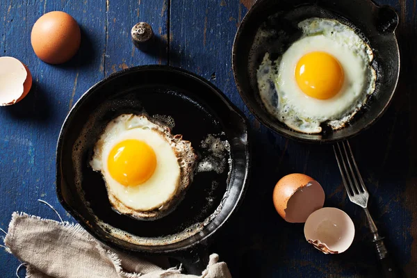 Fried eggs in cast-iron skillets