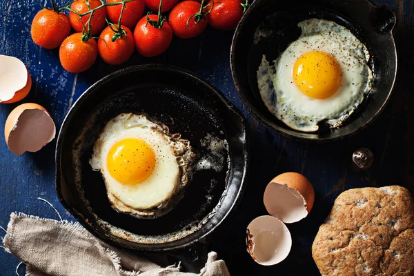 Skillets ahşap arka plan üzerinde kızarmış yumurta — Stok fotoğraf