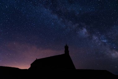 Night stars over Pointe du Van church in Brittany, France. clipart