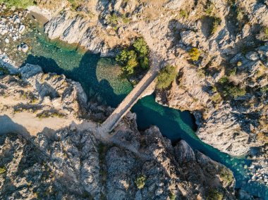 Aerial top view over ancient arched Genoese stone bridge at Asco. Corsica, France.  clipart