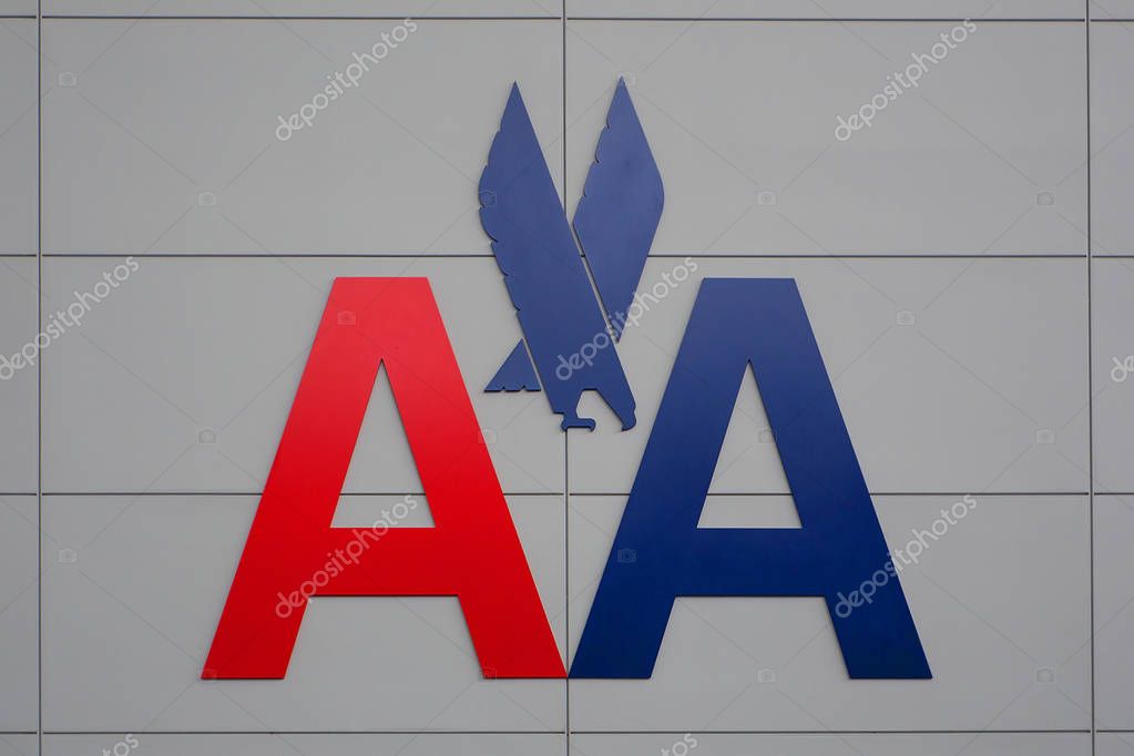NEW YORK CITY - MAY 20, 2015: American Airlines logo on JFK airport wall. American Airlines is the world's largest airline with 108 million passengers.