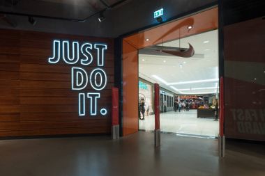 BERLIN, GERMANY - CIRCA JULY, 2017: JUST DO IT sign inside Nike shop. Nike is one of the world's largest suppliers of athletic shoes and apparel. The company was founded on January 25, 1964.  clipart