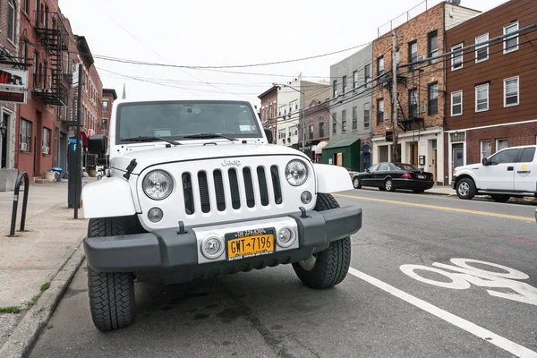 NEW YORK CITY - MAY 18, 2015: Jeep Wrangler parked on the street. The Jeep Wrangler is a compact and mid-size four-wheel drive off-road and sport utility vehicle (SUV), manufactured by Jeep.