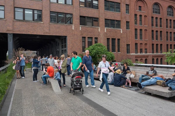 NEW YORK CITY - MAY 16, 2015: People walking on the High Line Park. The High Line is a park built on an historic freight rail line elevated above the streets in the West Side.