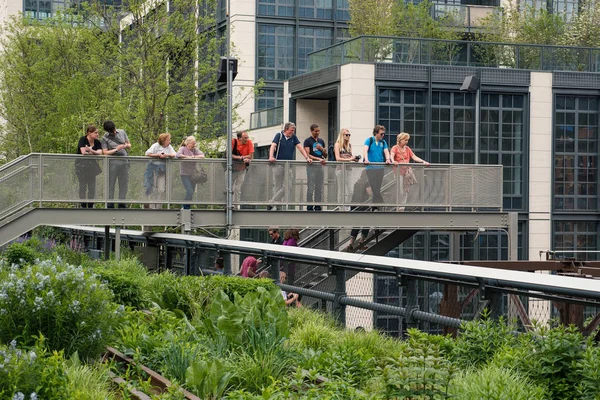 NEW YORK CITY - MAY 16, 2015: People relaxing on the High Line Park. The High Line is a park built on an historic freight rail line elevated above the streets in the West Side.