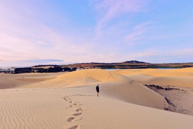Tourist in white sand dunes clipart