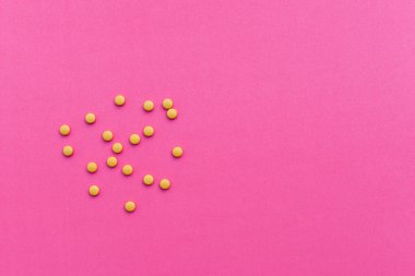 Sarı tıp hapları pembe bir arka plan üzerinde