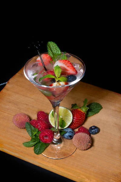 A glass of cool drink. fruit mix lemon strawberry raspberry. Berry milk soft drink.