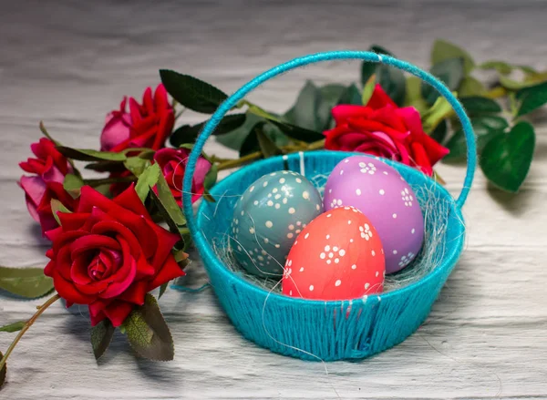 Easter Holiday. Funny eggs and flowers in the basket.