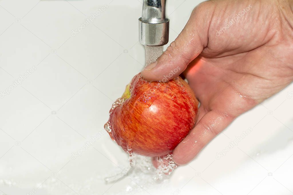 washing apple. Healthy eating concept. Red Apple