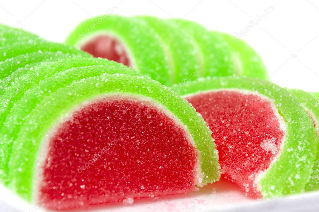 Slices of marmalade in the shape of a watermelon, on a light background. Sweet treat.