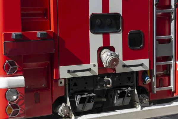 Fragment of a red fire engine. Fire technological transport. Fire engines are preparing for fire fighting.