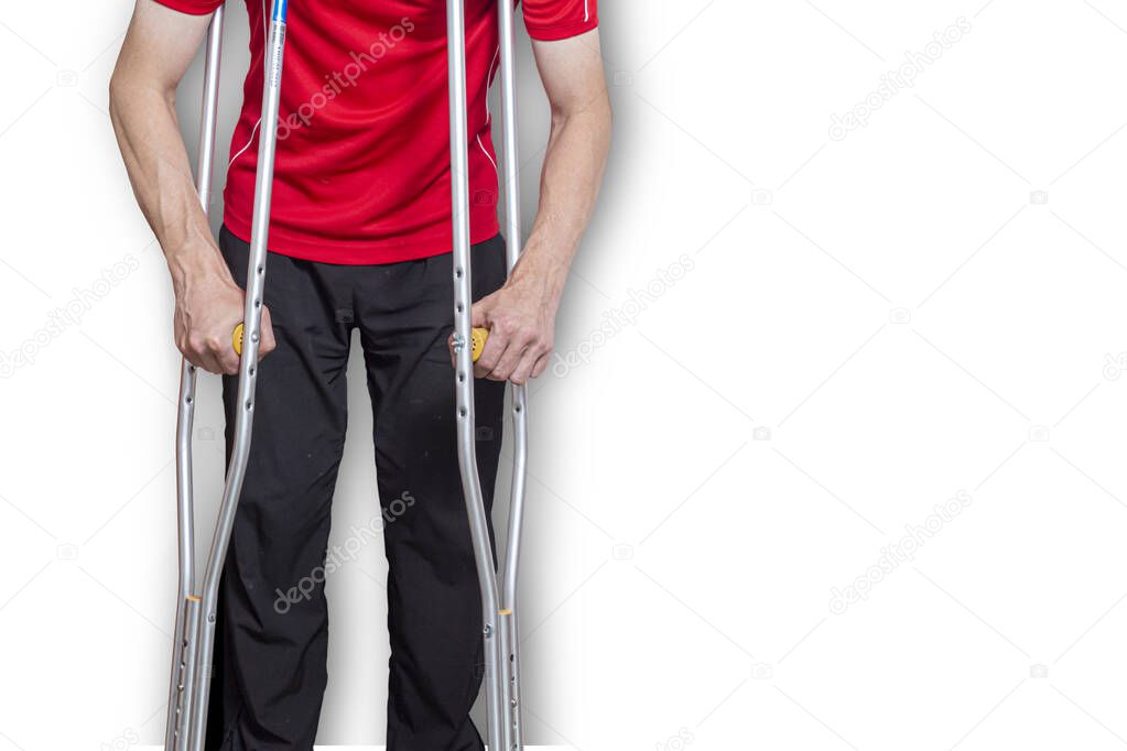 man on crutches isolated on a white background. Concept: leg injuries, restriction in human movement, limited abilities.