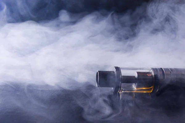 Abstract image of an electronic cigarette in smoke. copy space. The concept of the dangers of smoking, an alternative to cigarettes, bad habits. — 스톡 사진