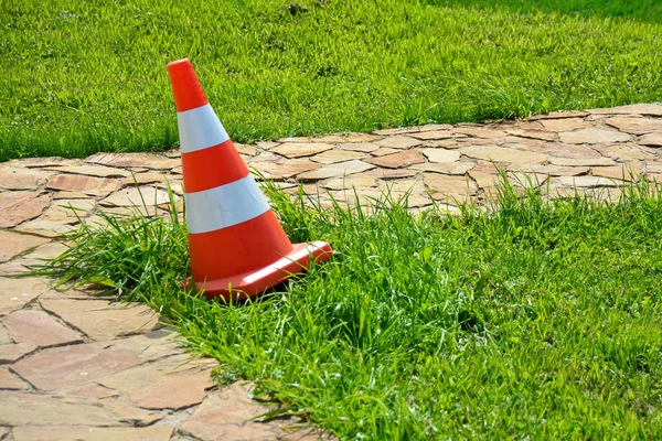 Transport cone, with white and orange. Concept: Direction of transport or flow of people, road safety. Stock Picture