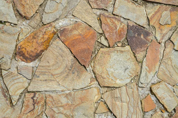 Texture of large flat stones. Abstract natural background. The concept of masonry made from natural, unprocessed stones. — Stock Photo, Image