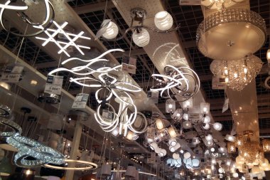 A large number of ceiling lamps, chandeliers in the store. soft focus.