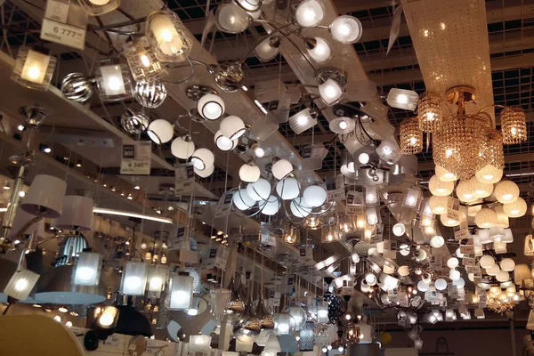 A large number of ceiling lamps, chandeliers in the store. soft focus.