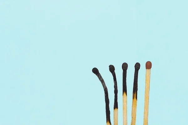 matchsticks in different degrees of burning. Copy space. Concept: international matchstick day, evolution, differences between people, racial social differences, stages of burning.