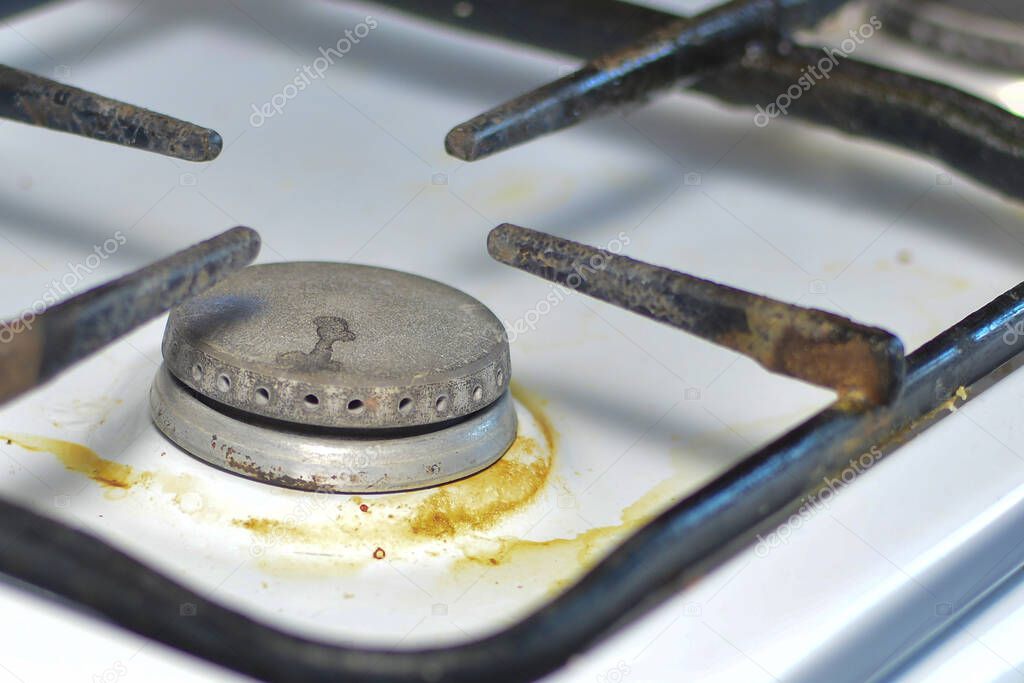 unwashed gas stove. The concept of care and maintenance of gas appliances, safe use and hygiene.
