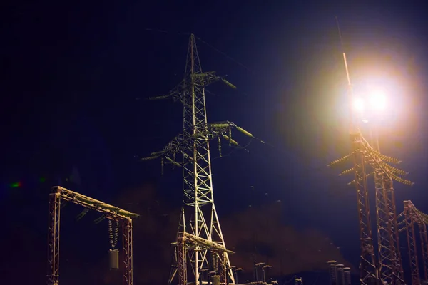High voltage substation at night. Soft focus. The concept of energy consumption, electricity consumption, problems in the energy sector.