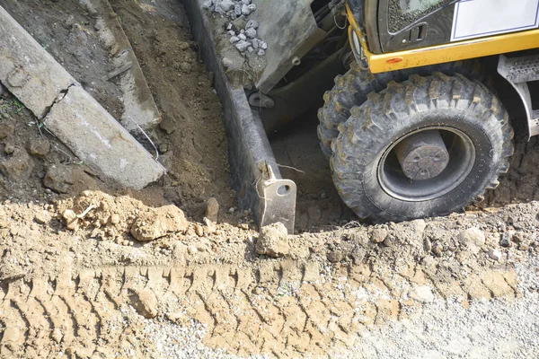 Close-up of construction equipment. Soil extraction by excavator. Improvement and construction, road works. Works on landscaping the park area.