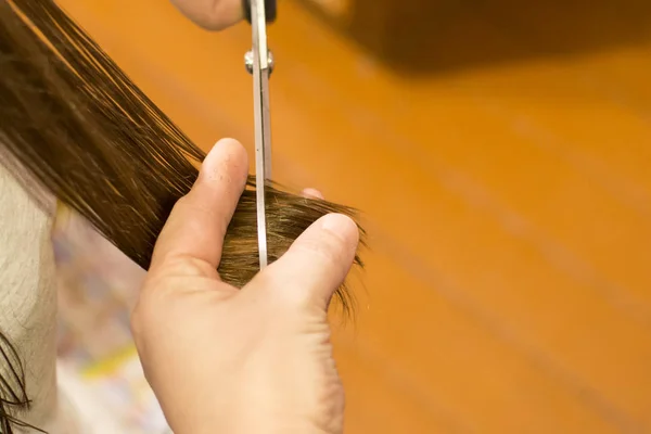 Haircut at home. Concept: hair care, savings in a hairdressing salon, haircut for children at home.