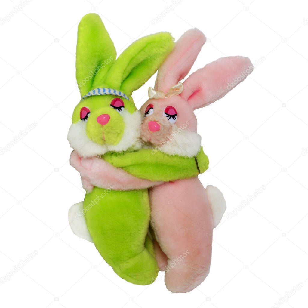 two soft toy rabbits. Hares hug each other with their eyes closed. Objects are isolated on a white background for a project or design.