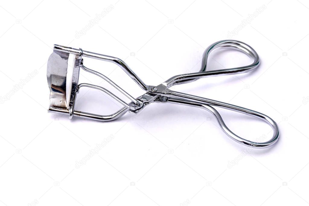 Tool for curling eyelashes on a white background. Close-up.