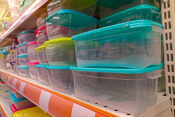 Plastic food containers on a shelf in a store. Colorful containers on a shelf. Abstract background. close-up.