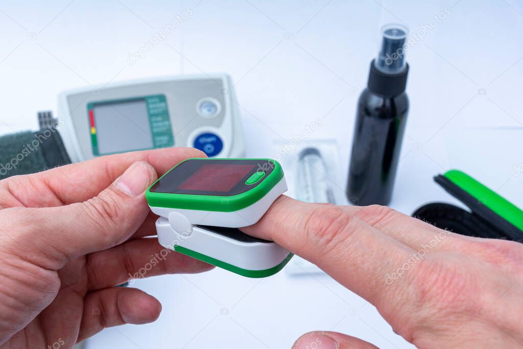 Close-up of a pulse oximeter on a finger. Measurement of oxygen in the blood.